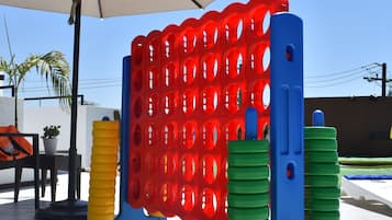 A children's play area with a climbing structure and an umbrella.