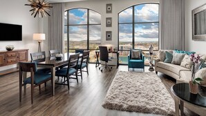 A spacious living room with a large window offering a view of the mountains, a dining area with a wooden table and chairs, and a cozy seating area with a sofa and a coffee table. - Element by Marriott Huntsville (Huntsville)