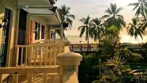 A balcony with a view of the ocean and palm trees. - Northsky Beach Resort (Sogod)