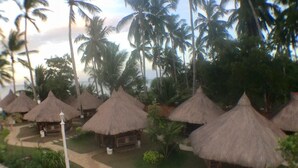 A resort with thatched-roof huts arranged in a circular pattern around a central pool area. - Northsky Beach Resort (Sogod)