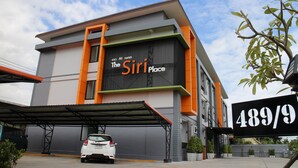 A building with a sign reading "The Siri Place" and a parking sign indicating "489/9". - The Siri Place (Udon Thani)