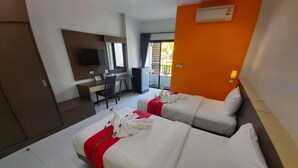 A hotel room with two beds, a desk, and a chair. - The Siri Place (Udon Thani)