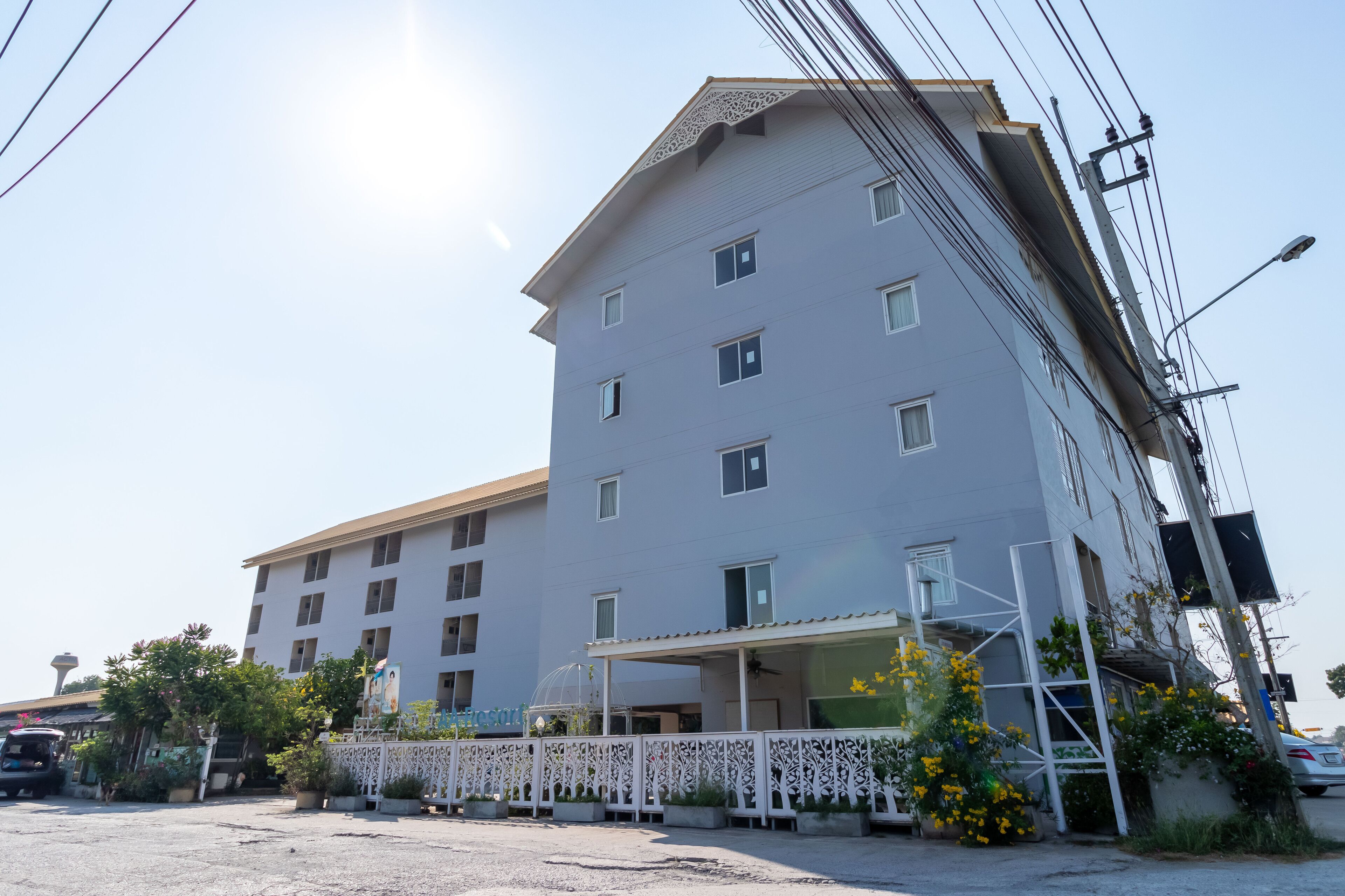 A multi-story hotel with a flat roof and a covered entrance.