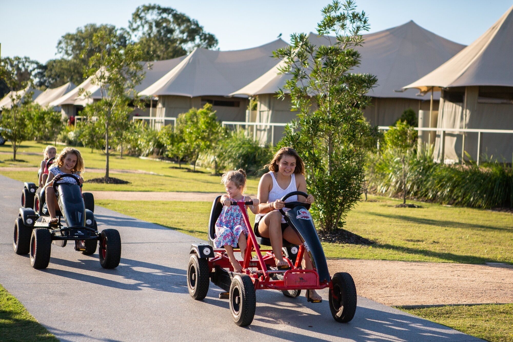 A pathway with people riding go-karts.