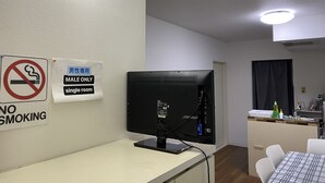 A room with a computer, a no-smoking sign, and a male-only sign. - Palette Takashimadaira - Hostel (Tokyo)