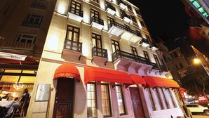 A hotel with a classic facade, multiple balconies, and red awnings. - Pera Residence (Istanbul)