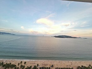 A beach with clear skies and calm waters. - Gold Ocean Nha Trang (Nha Trang)