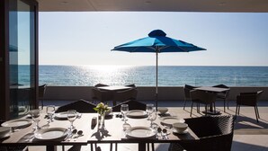 A dining table set for two with a view of the ocean. - Aureo La Union (San Fernando)