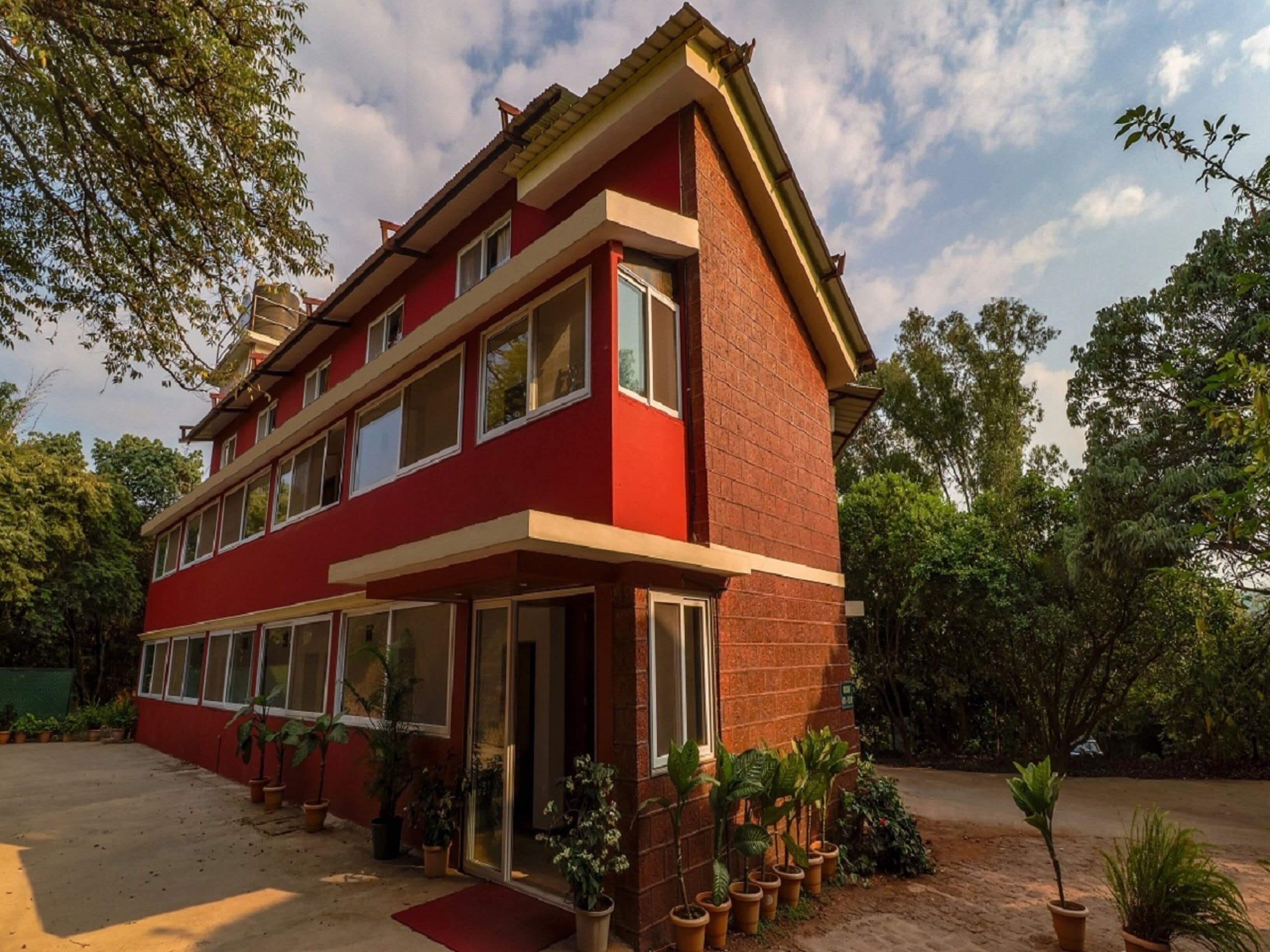 A two-story building with a red facade and multiple windows.