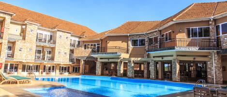 Outdoor pool, pool umbrellas, lifeguards on site