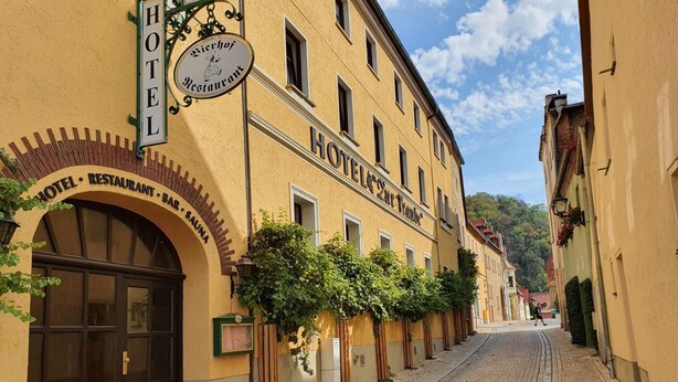 A hotel with a sign indicating it offers a restaurant and sauna. - Hotel Restaurant Zur Traube (Freyburg)