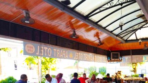 A restaurant with outdoor seating, a covered area, and a sign indicating it is a place for breakfast and lunch. - Best Life Apart Hotel (Alanya)