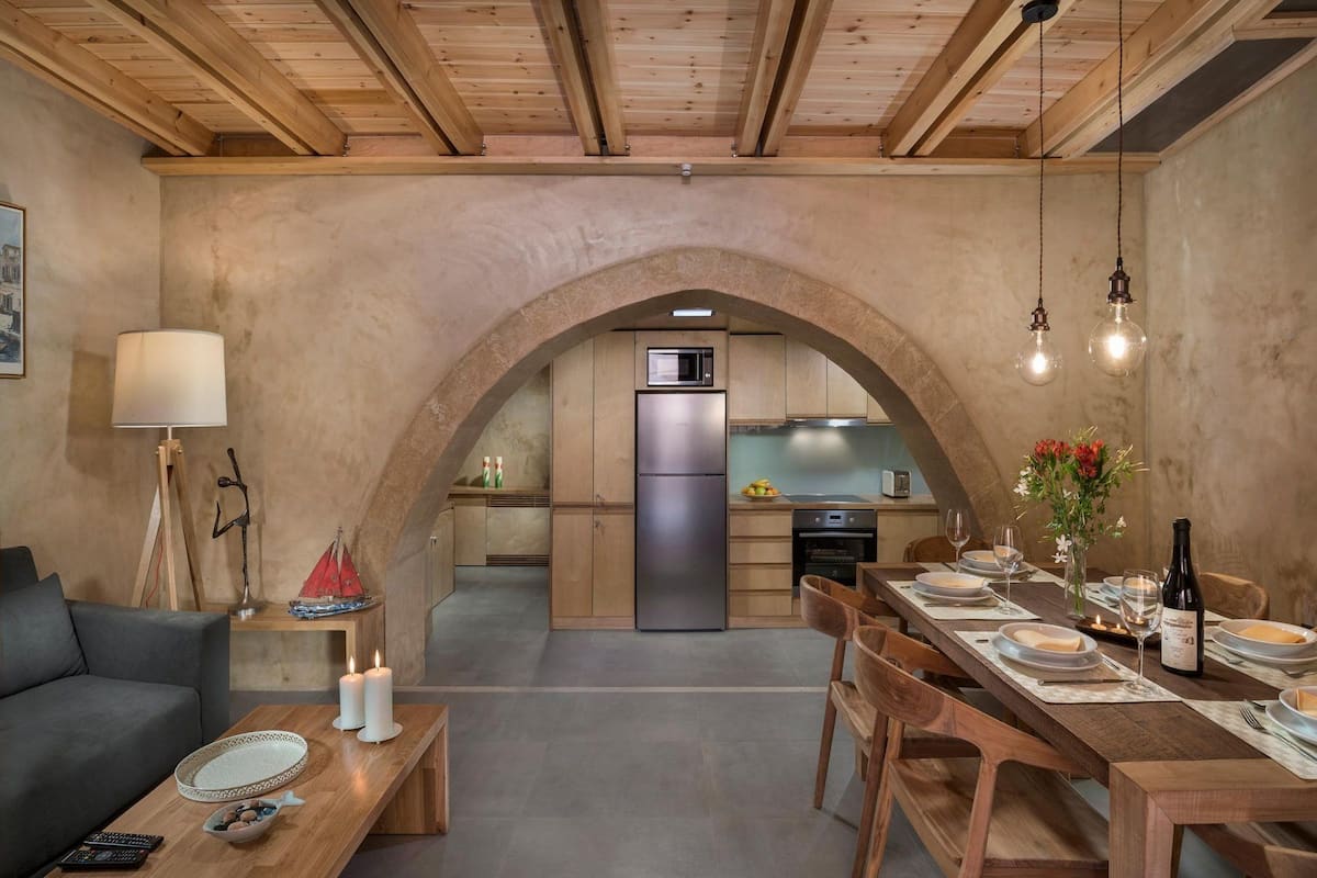 A modern kitchen with an archway leading to a dining area.