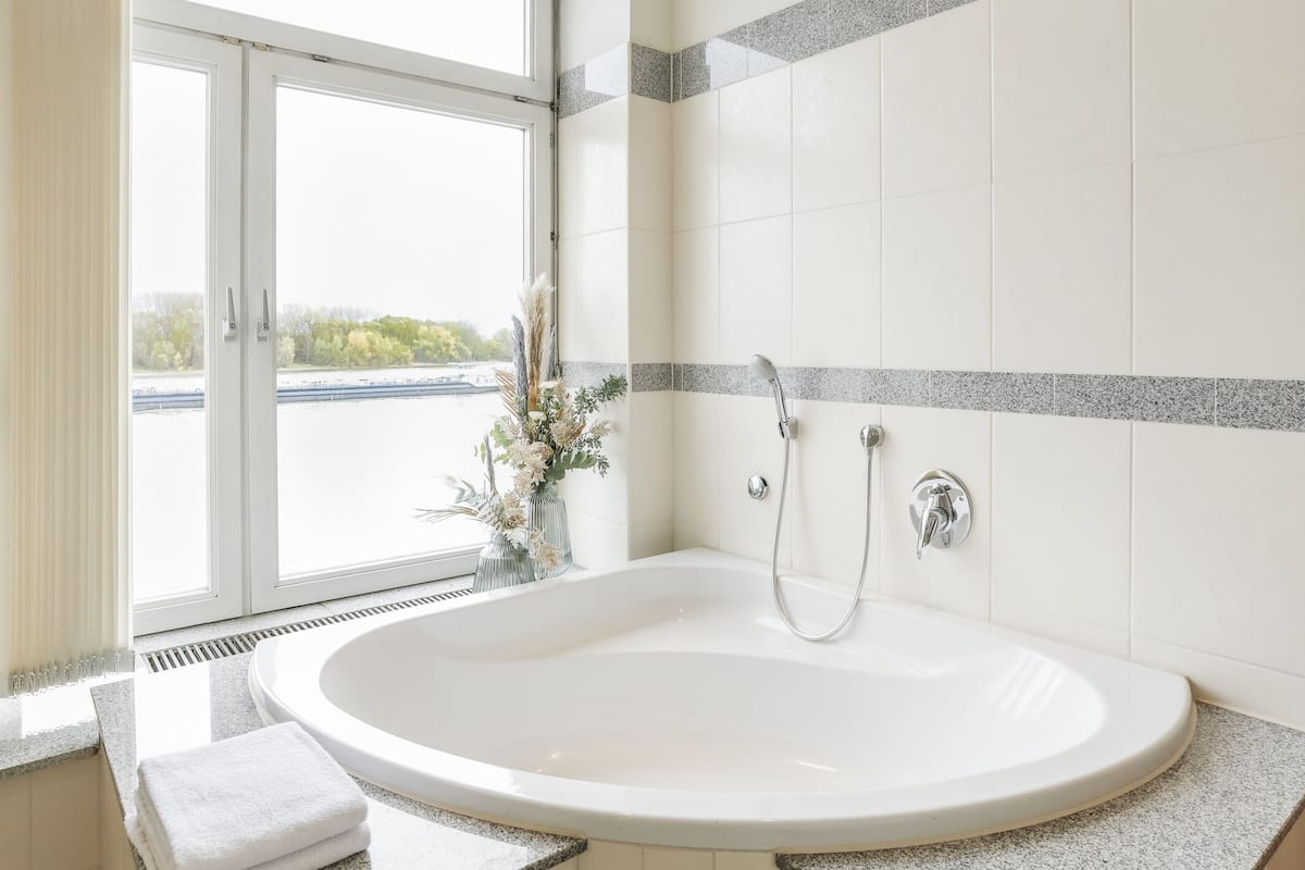 deluxe suite, 1 queen bed, non smoking, river view | bathroom | shower, free toiletries, hair dryer, towels