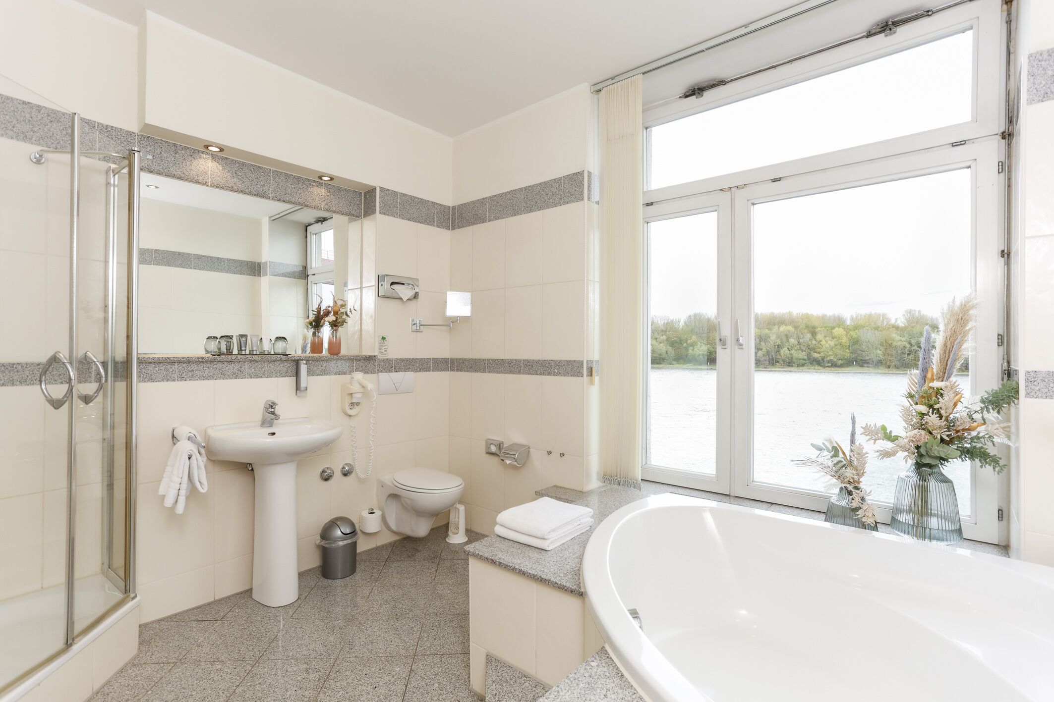 deluxe suite, 1 queen bed, non smoking, river view | bathroom | shower, free toiletries, hair dryer, towels