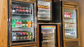 A row of refrigerators with shelves stocked with beverages and condiments. - Holiday Inn Express & Suites Kingston-Ulster by IHG (Lake Katrine)