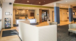A hotel lobby with a reception desk, seating area, and a refrigerator stocked with beverages. - Holiday Inn Express & Suites Kingston-Ulster by IHG (Lake Katrine)