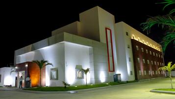 Contemporary hotel building with a striking vertical accent and well-lit facade.
