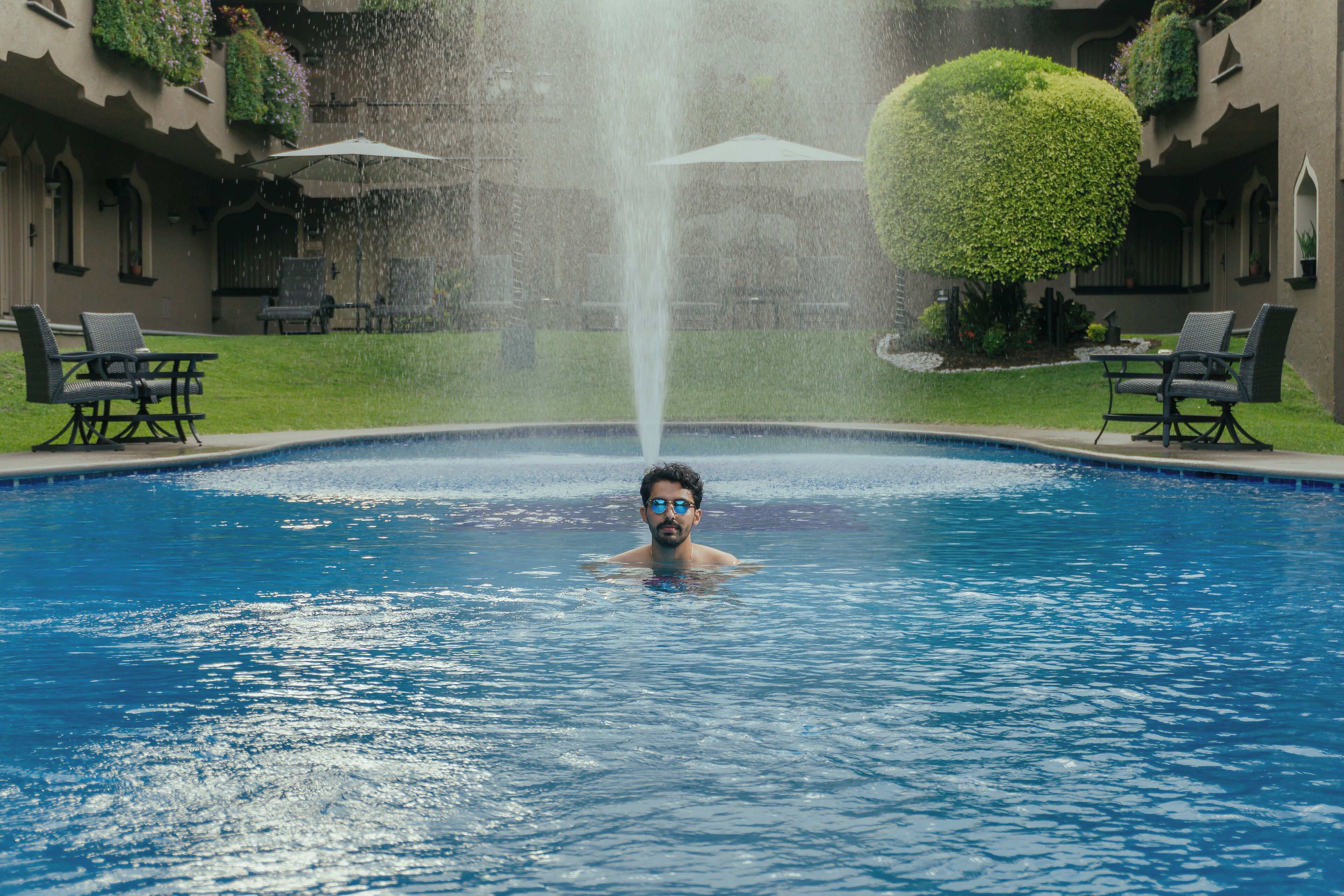 outdoor pool, open 6:00 am to 9:30 pm, pool umbrellas, pool loungers