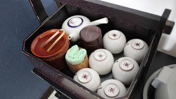 A box containing various tea sets and a teapot.