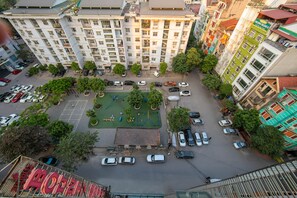 Un immeuble à plusieurs étages doté d’un parking et d’espaces verts.