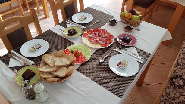 A table set for breakfast with various food items and utensils. - St. George B&B (Plitvicka Jezera)