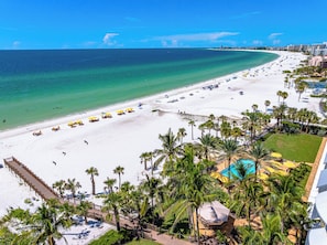 A beach resort with a white sandy beach, palm trees, and a clear blue ocean. - The Residences on Siesta Key within Hyatt Residence Club (Siesta Key)