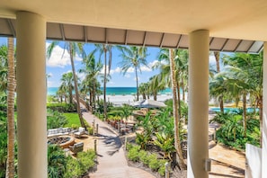 A covered outdoor area with a pathway leading to a pool and beach. - The Residences on Siesta Key within Hyatt Residence Club (Siesta Key)
