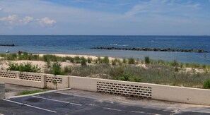 A parking lot with a view of the beach and ocean.