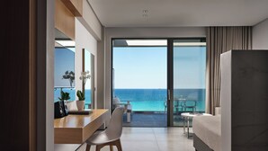 A modern hotel room with a balcony, a desk with a chair, a bed, and a view of the ocean. - Lesante Blu - The Leading Hotels of the World, Adults Only (Zakynthos)