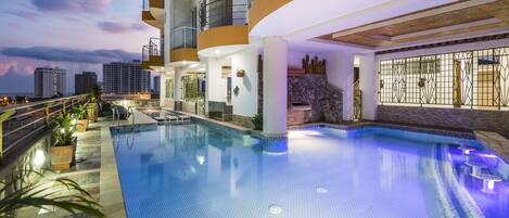 Outdoor pool, open 10:00 AM to 7:00 PM, pool umbrellas, pool loungers