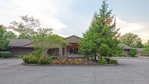 A lodge with a sign reading "WORTHINGTON LODGE," surrounded by landscaped gardens and trees.