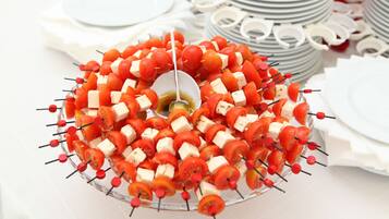 A platter of skewered tomatoes and cheese.