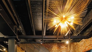 A staircase with a brick wall, metal railing, and potted plants. - Hotel Hive (Washington)