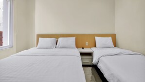 A hotel room with two single beds, a nightstand, and a window. - Vivo Stay (Medan)