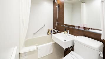 A modern bathroom with a bathtub, a sink, and a toilet. There is a showerhead above the bathtub, a mirror above the sink, and a towel hanging on the side of the bathtub.