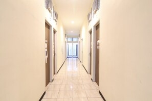 A hotel hallway with doors labeled "DRM 1" and "BED" indicating room types. - MADOR Malang Dorm Hostel (Malang)