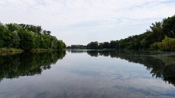 A calm river with dense greenery on both sides.