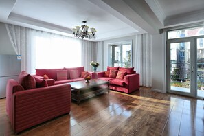Deluxe Two-Bedroom Suite | Living room | 42-inch flat-screen TV with cable channels, TV