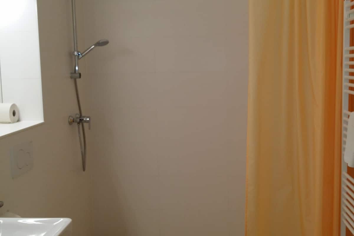 suite, balcony, garden view | bathroom | shower, free toiletries, hair dryer, towels