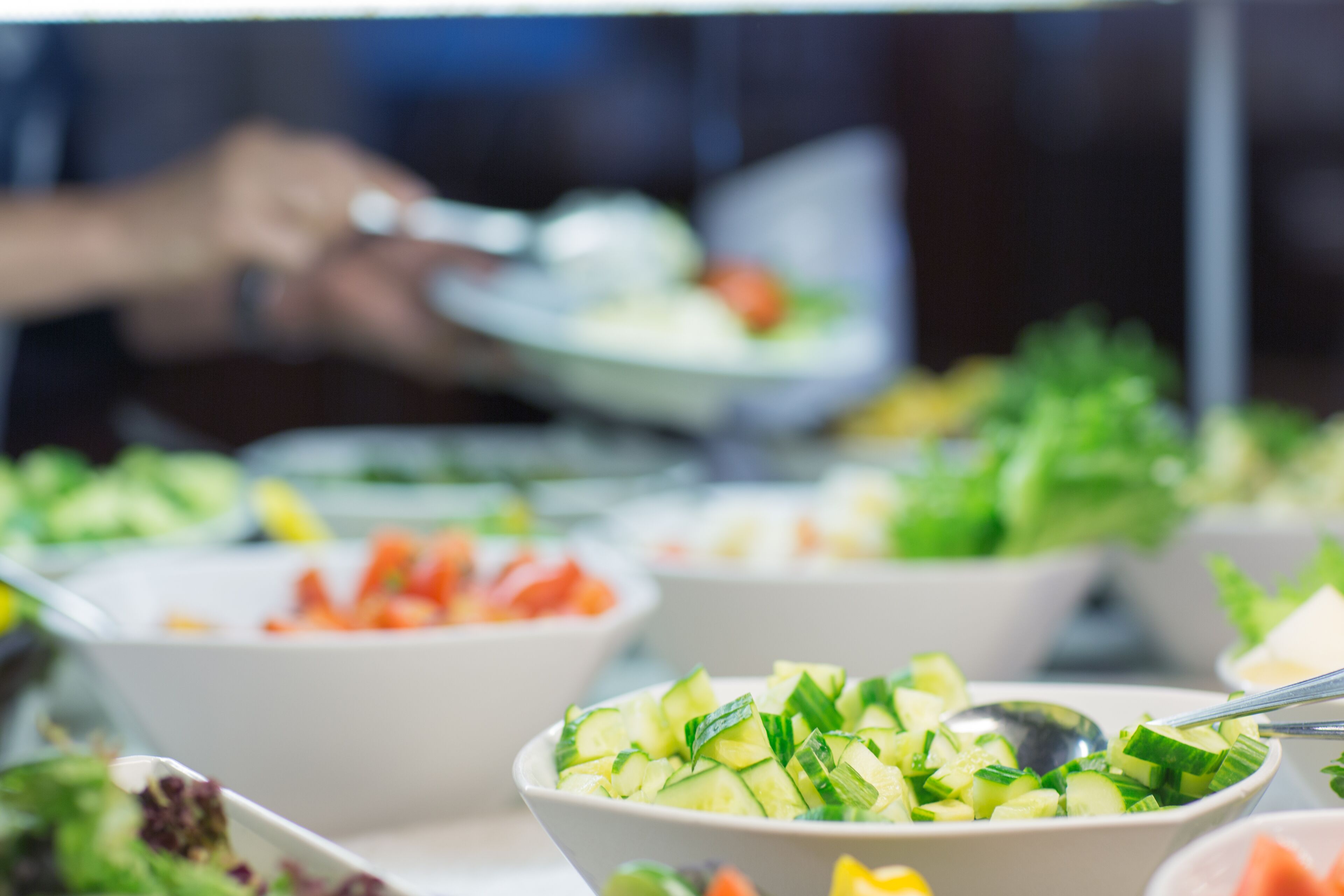 A buffet with various dishes including salads and vegetables.