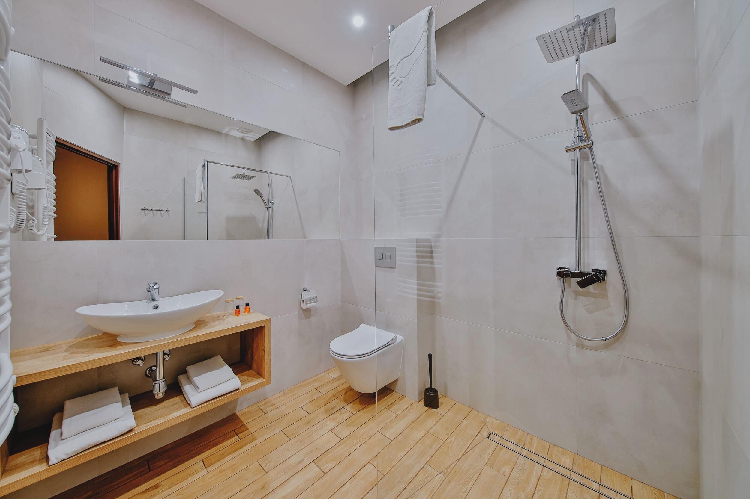Un baño moderno con lavamanos, inodoro y ducha.