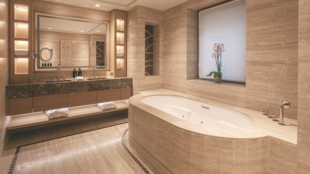 A modern bathroom with a large freestanding bathtub, a double vanity with a large mirror, and a window with a view of the outdoors. - Castelfalfi (Montaione)