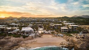 A resort with multiple buildings, a beach, and mountains in the background. - Chileno Bay Resort & Residences, Auberge Collection (Cabo San Lucas)