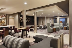 A modern lounge area with seating, tables, and a bar. - Courtyard El Paso East/i-10 (El Paso)