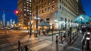 A hotel with a classic architectural style, a prominent entrance, and a well-lit plaza area. - Hyatt House Jersey City (Jersey City)