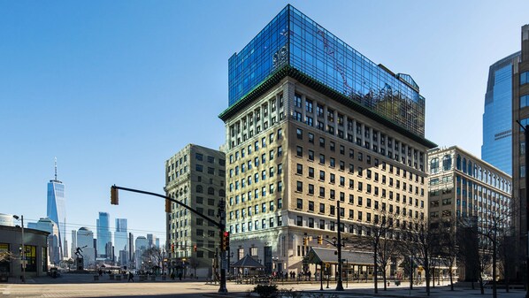 A multi-story building with a modern glass facade and traditional architecture. - Hyatt House Jersey City (Jersey City)