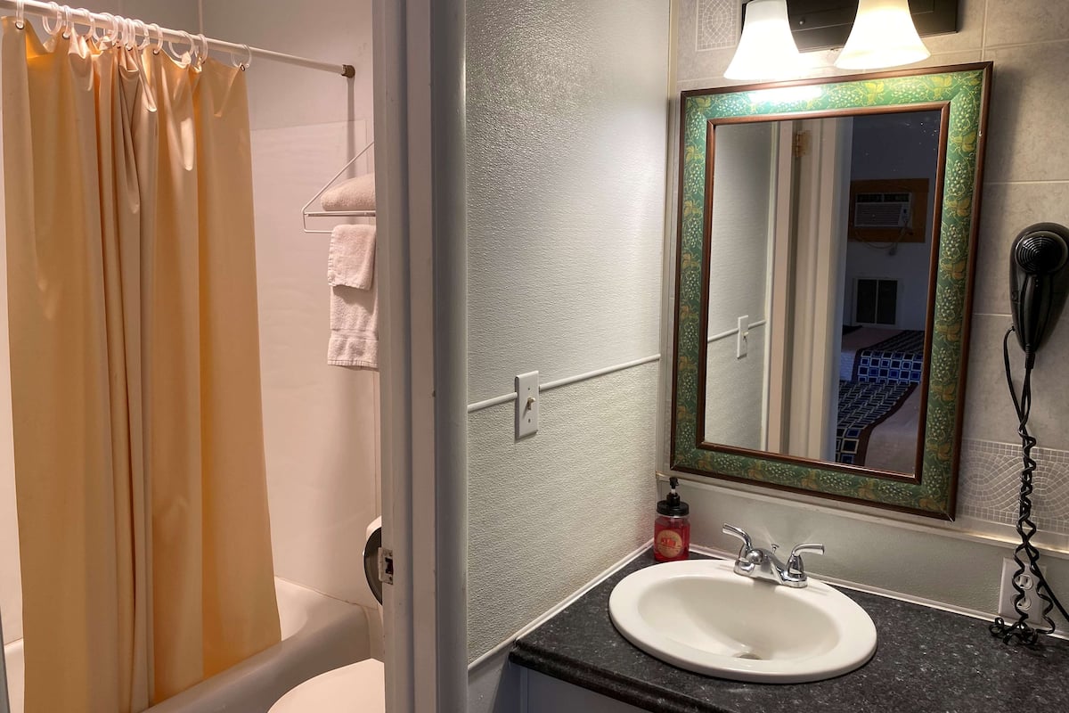 room, 2 queen beds | bathroom | combined shower/bathtub, deep-soaking bathtub, free toiletries, towels