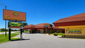 A Fairview Inn with a Mango Leaf sign, a parking lot, and an Egg Rolls sign.
