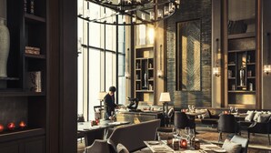 Un comedor moderno con una isla central, arreglos de asientos y un amplio ventanal que proporciona luz natural.